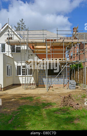 House bedroom extension roof construction work to rear of existing detached house seen from back garden Essex England UK see 'More Info' note below Stock Photo