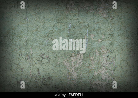 Grayish green weathered and distressed textured wall, dark around the edges Stock Photo