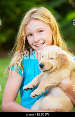 Adorable Cute Young Girl Playing and Hugging Puppies Stock Photo