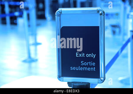 Exit sign in an airport with blue toned Stock Photo