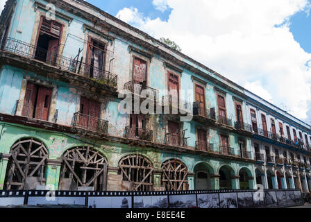 A dilapidated row of apartment buildings some of which are still occupied on a street near the Capital building in Havana Cuba Stock Photo