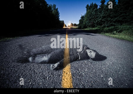 Empty Road With Dead Body's Ghost in the Middle At Night Stock Photo