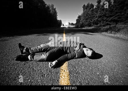 Empty Road With Dead Body in the Middle At Night Stock Photo