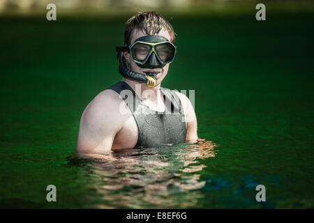 Funny Young Adult Snorkeling in a river with Goggles and Scuba. Stock Photo
