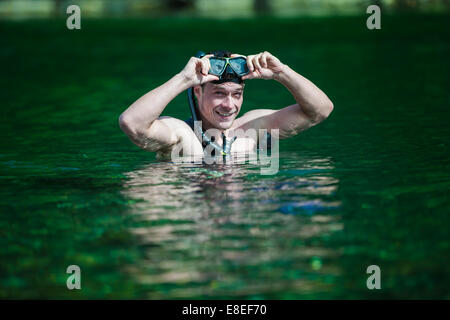 Young Adult Snorkeling in a river with Goggles and Scuba. Stock Photo