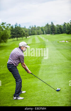 Mature Golfer on a Golf Course (ready to swing) Stock Photo