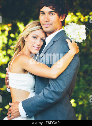 Romantic Wedding COuple Embracing. Newlyweds on Wedding Day Stock Photo