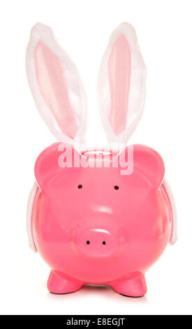 piggy bank wearing easter rabbit ears cutout Stock Photo