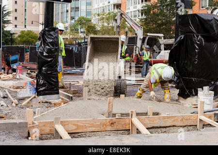 Municipal construction workers pouring concrete on roadwork project - Washington, DC USA Stock Photo