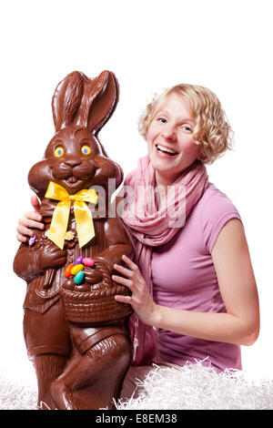 Girl Laughing and Holding a HUGE Chocolate Easter Bunny Isolated On White Background Stock Photo