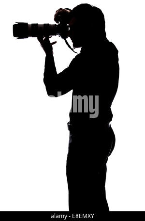 Professional photographer taking a picture in silhouette isolated over white background Stock Photo