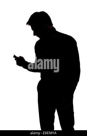 Man texting with one hand in silhouette isolated over white background Stock Photo