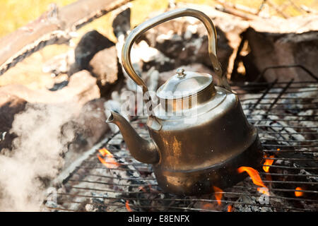 Kettle with water heated on the fire Stock Photo - Alamy