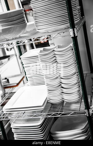 Stack of Cleaned Dishes in a Restaurant Room Stock Photo