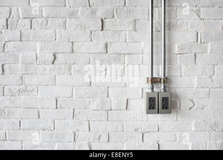 Electrical Socket on a White Painted Brick Wall Stock Photo