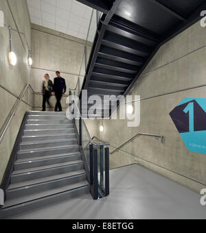 Oasis Academy Hadley, Enfield, United Kingdom. Architect: John McAslan & Partners, 2013. Stairwell view with figures in motion. Stock Photo