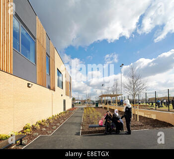 Oasis Academy Hadley, Enfield, United Kingdom. Architect: John McAslan & Partners, 2013. Perspective of facade with approach. Stock Photo