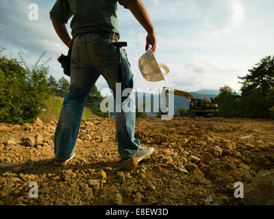 closeup, back view of engineer standing on construction site, dramatic light Stock Photo