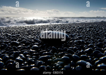 Surf, black pebbles on the lava beach of Reynisfjara near Vík í Mýrdal, South Coast, Iceland Stock Photo