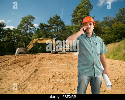 engineer talking on the phone on construction site Stock Photo