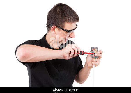Male serviceman working with cables and electrical outlet. Stock Photo