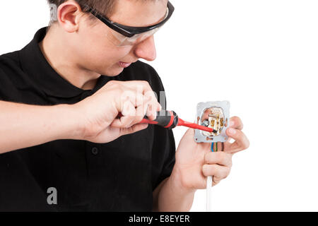 Male serviceman working with cables and electrical outlet. Stock Photo