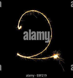 burning sparkler stick and writing sparkling text . number two  isolated on black background Stock Photo
