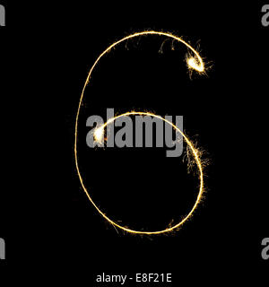 burning sparkler stick and writing sparkling text . number six  isolated on black background Stock Photo