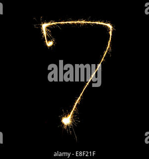 burning sparkler stick and writing sparkling text . number seven  isolated on black background Stock Photo