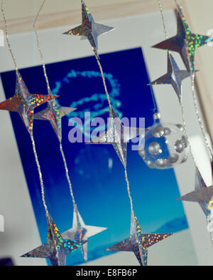 Close-up of a string of Christmas stars hand made from metallic paper Stock Photo