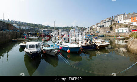 Panoramic / panorama of fishing boat / boats moored / tied up in the sea harbour / Mevagissey harbor in Cornwall. UK. Stock Photo
