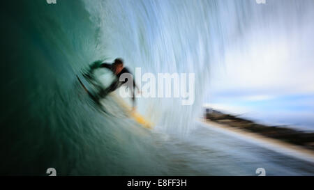 Blurred motion shot of a man surfing, Malibu, California, USA Stock Photo