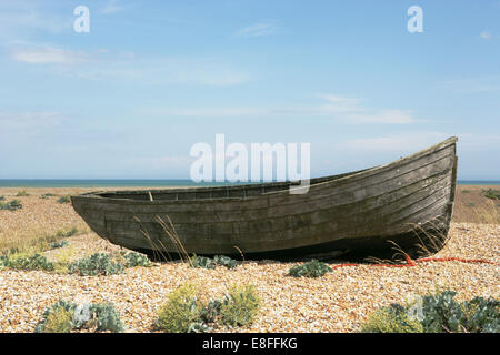 Old rowing boat on pebble beach, Dungeness, Kent, England, United Kingdom Stock Photo
