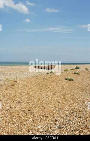 Old rowing boat on pebble beach, Dungeness, Kent, England, United Kingdom Stock Photo