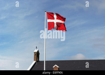 Danish flag and church, Sonderho, Fanoe, Jutland, Denmark Stock Photo