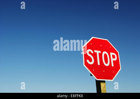 Stop sign against blue sky Stock Photo