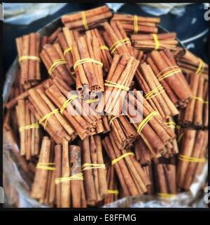 Bowl of cinnamon sticks for sale in a market Stock Photo