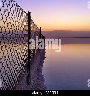 Salt deposits on fence, Dead Sea, Israel Stock Photo