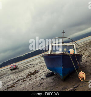 Fishing boat on beach at low tide Stock Photo