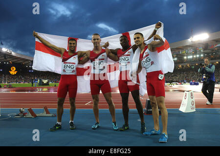 Adam Gemili, Harry Aikines-Aryeetey, Richard Kilty and Danny Talbot (all ENG) pose with the flag. England take the Silver Medal Stock Photo