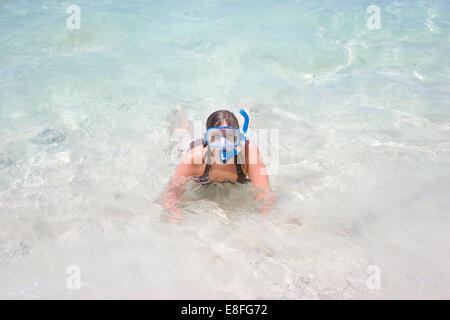 Woman in sea wearing snorkel mask Stock Photo