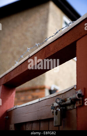 Barbed wire on top of a wooden gate Stock Photo