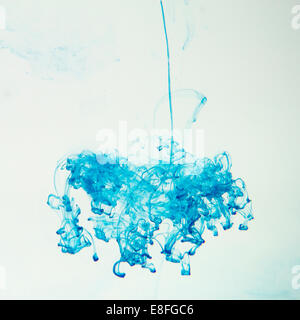 Blue ink dissolving in water Stock Photo