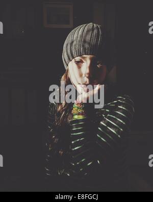Portrait of girl sitting in shadows Stock Photo