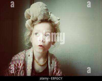 Portrait of a Girl with a teddy bear on her head Stock Photo