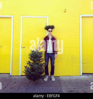 Man with a Christmas tree Stock Photo