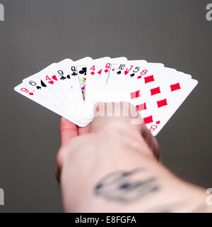 Man's hand holding paying  cards Stock Photo