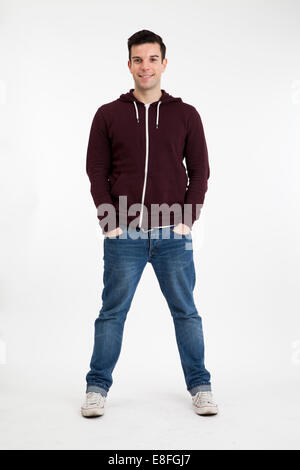 Portrait of a man standing with his hands in his pockets Stock Photo