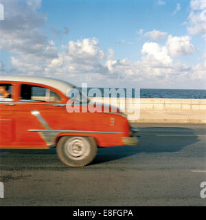 Vintage car driving along Malecon, Havana, Cuba Stock Photo