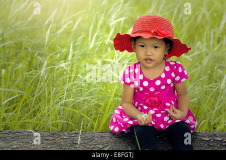 Portrait of girl sitting in a field Stock Photo